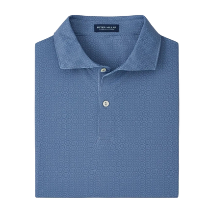 Folded blue polo shirt with 'Peter Millar' label on a light gray background